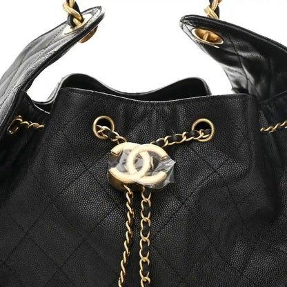 Black quilted caviar handbag with chain strap, gold CC charm, and flap clasp