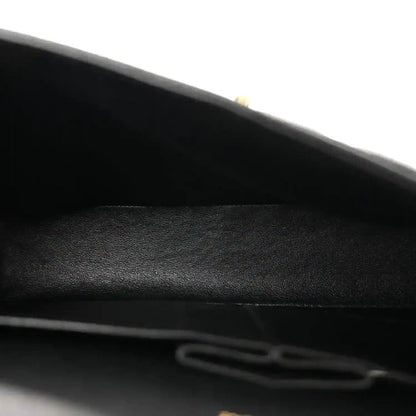 Chanel double flap bag interior closeup with black lining and seam detail