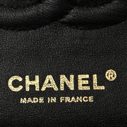 Chanel caviar leather stamp reading CHANEL on dark leather
