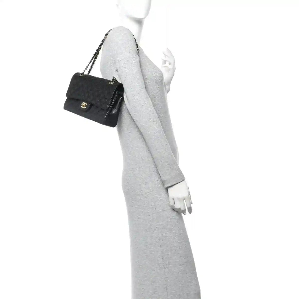 Chanel caviar quilted bag carried by a model with short gold chain strap