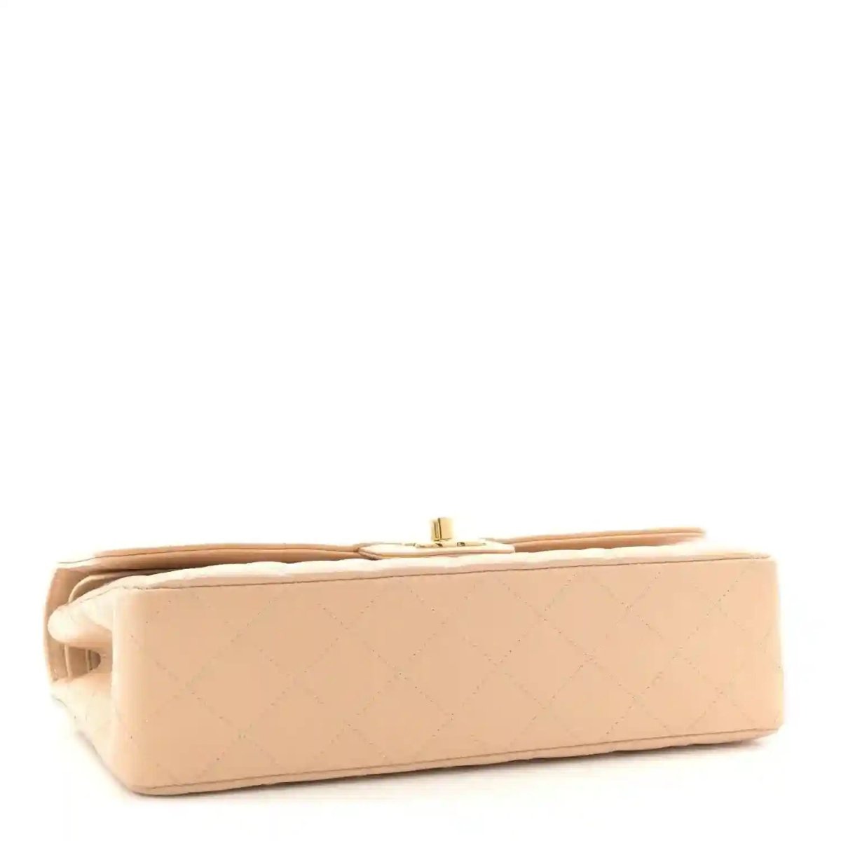 Beige quilted leather double flap bag shown from the side with top edge
