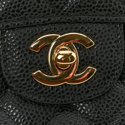 Chanel CC logo medallion on black caviar quilted flap