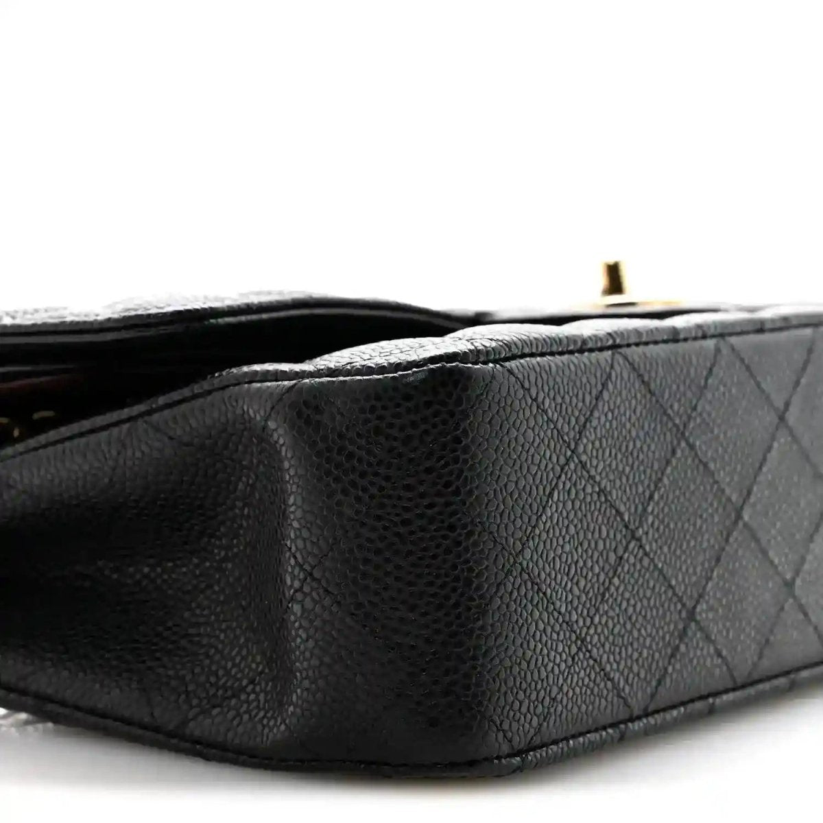 Black caviar quilted leather bag side detail with gold hardware