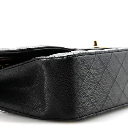 Black caviar quilted leather bag side detail with gold hardware