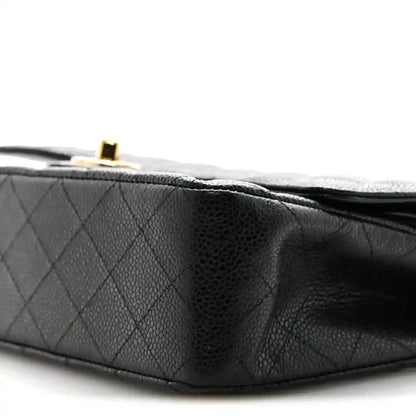 Black quilted caviar leather double flap bag, close-up of flap and edge