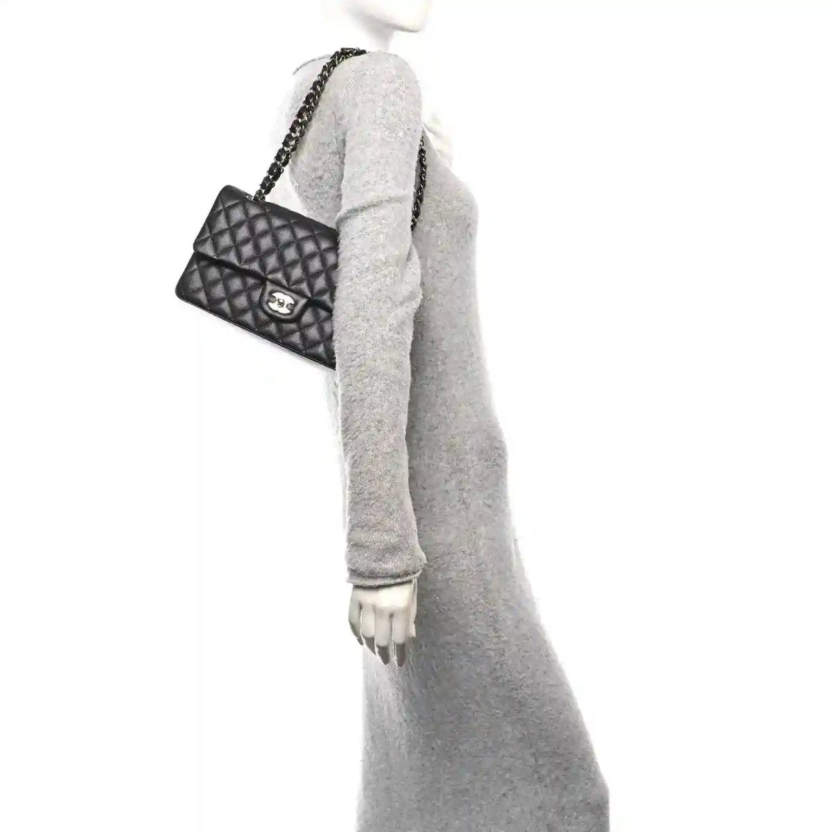 Quilted caviar leather shoulder bag with gold chain and CC clasp, held on arm