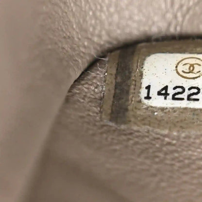 Chanel serial stamp “1422” on taupe leather interior close-up