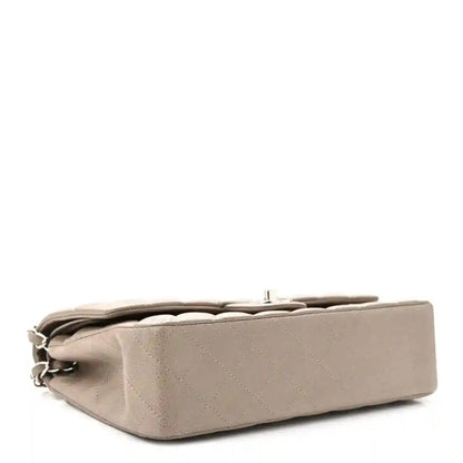 Taupe quilted leather flap bag angled view with silver chain strap and top opening