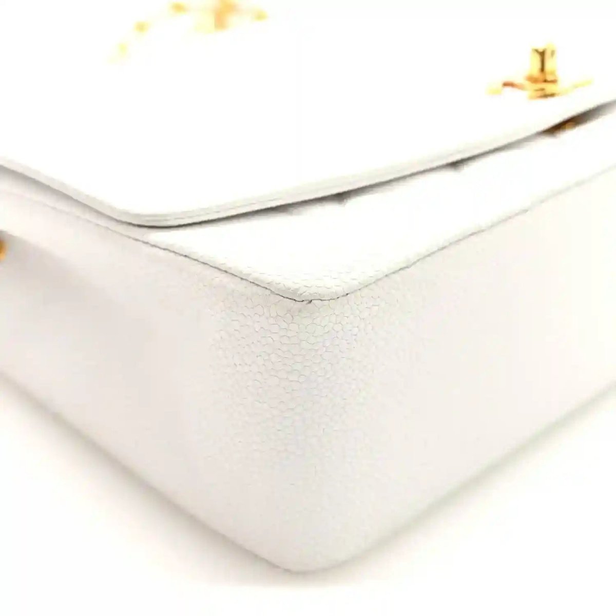 White Chanel caviar quilted single-flap bag corner with top edge and clasp