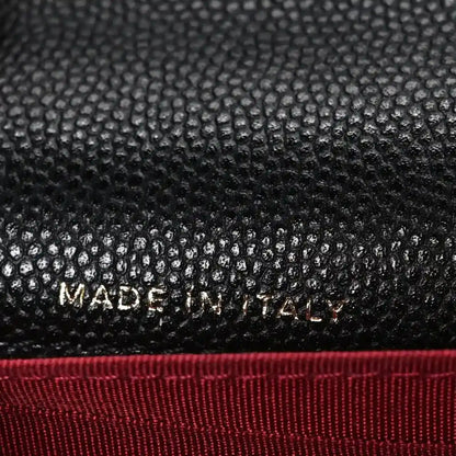 Chanel caviar quilted mini wallet on chain close-up with “MADE IN FRANCE”