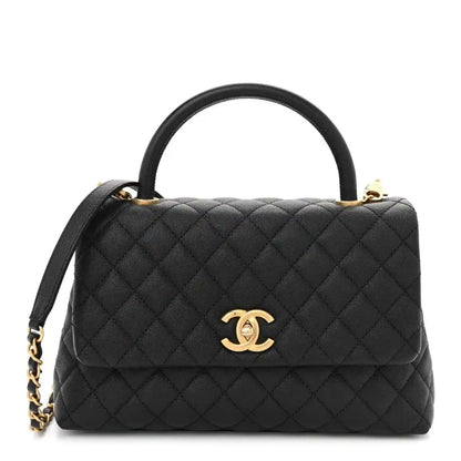 Black quilted small flap bag with gold Chanel logo, top handle, and chain strap.