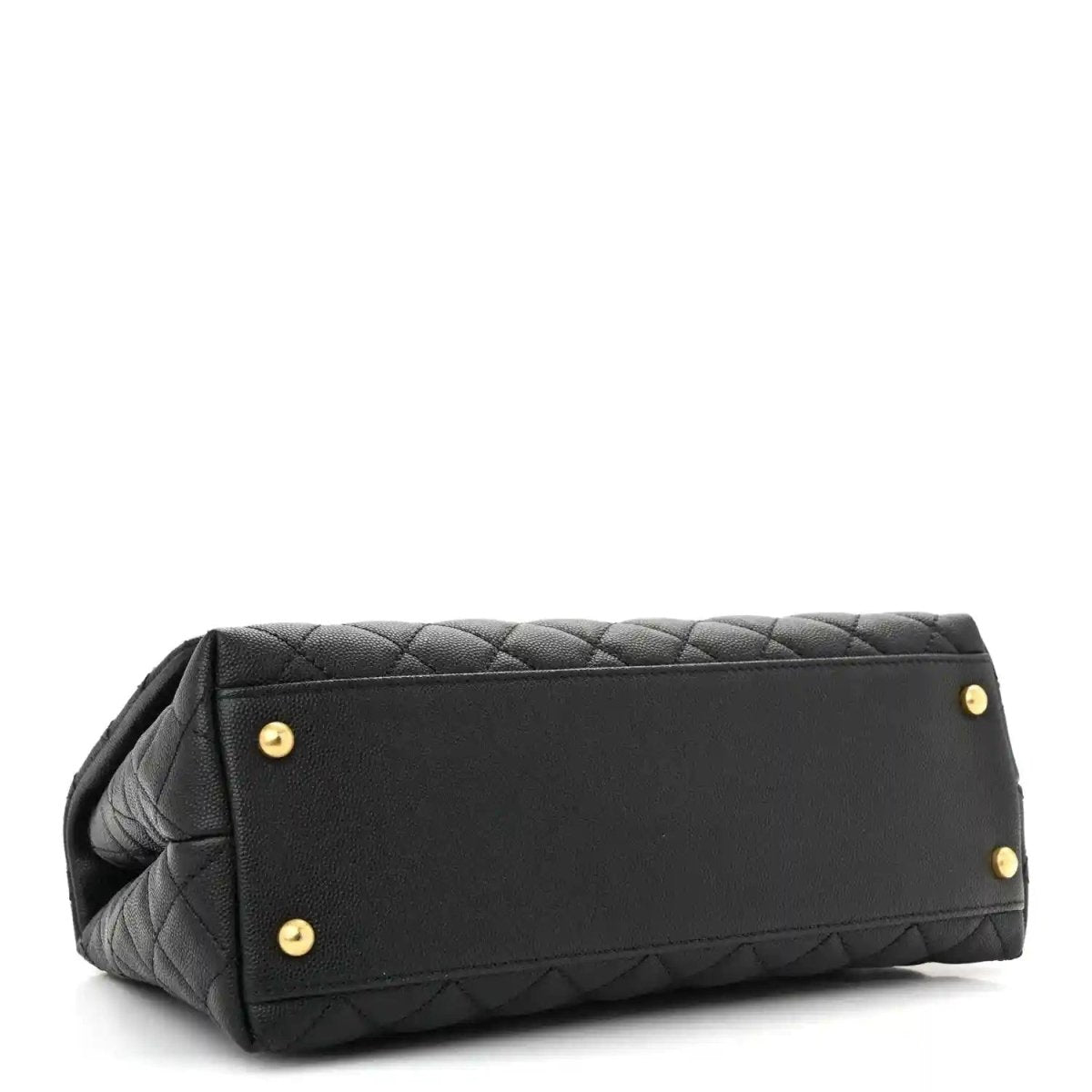 Black quilted small flap bag back panel with gold studs and top handle.
