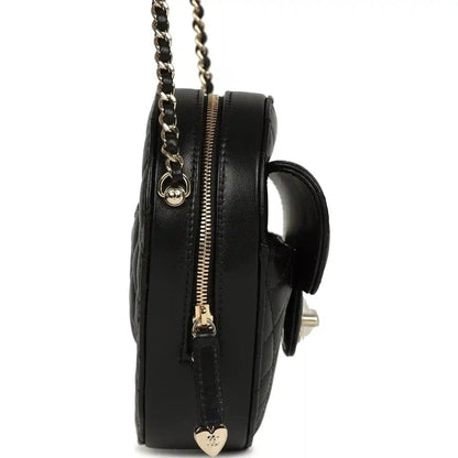 Chanel heart bag side view with chain strap, gold zipper, black quilted lambskin