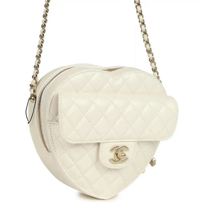 White quilted heart-shaped shoulder bag with gold-tone Chanel CC clasp and top zipper