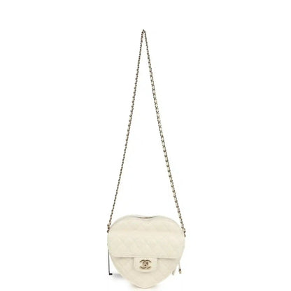 White quilted heart-shaped Chanel shoulder bag with chain strap and flap, gold hardware