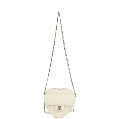 White quilted heart-shaped Chanel shoulder bag with chain strap and flap, gold hardware