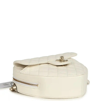 White quilted heart-shaped shoulder bag top with flap and gold-tone zipper hardware