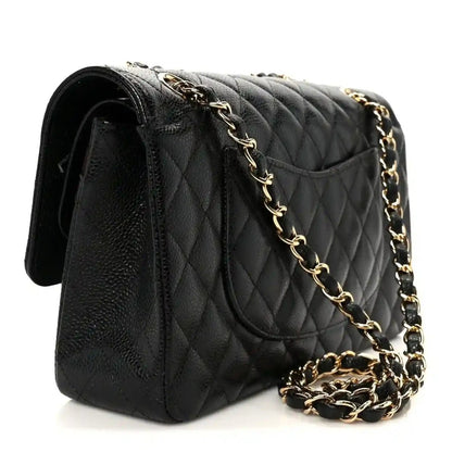 Chanel medium double flap bag, black quilted caviar leather side view with chain strap
