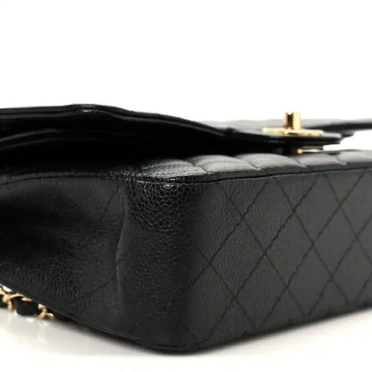 Chanel medium double flap bag with gold top clasp and black quilted caviar leather