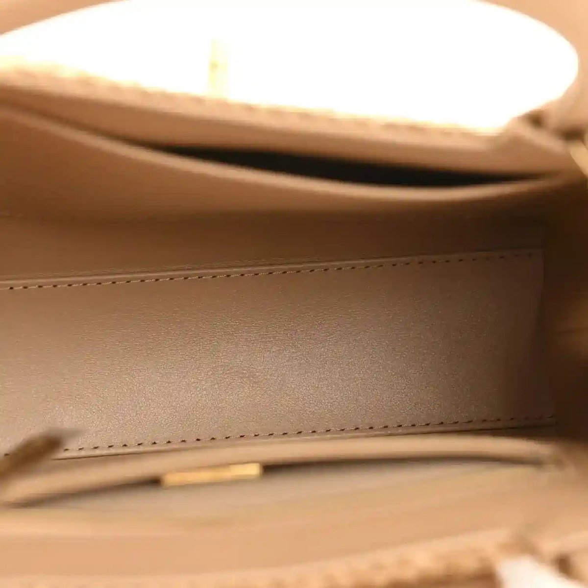 Beige leather lining and stitching inside nano flap bag