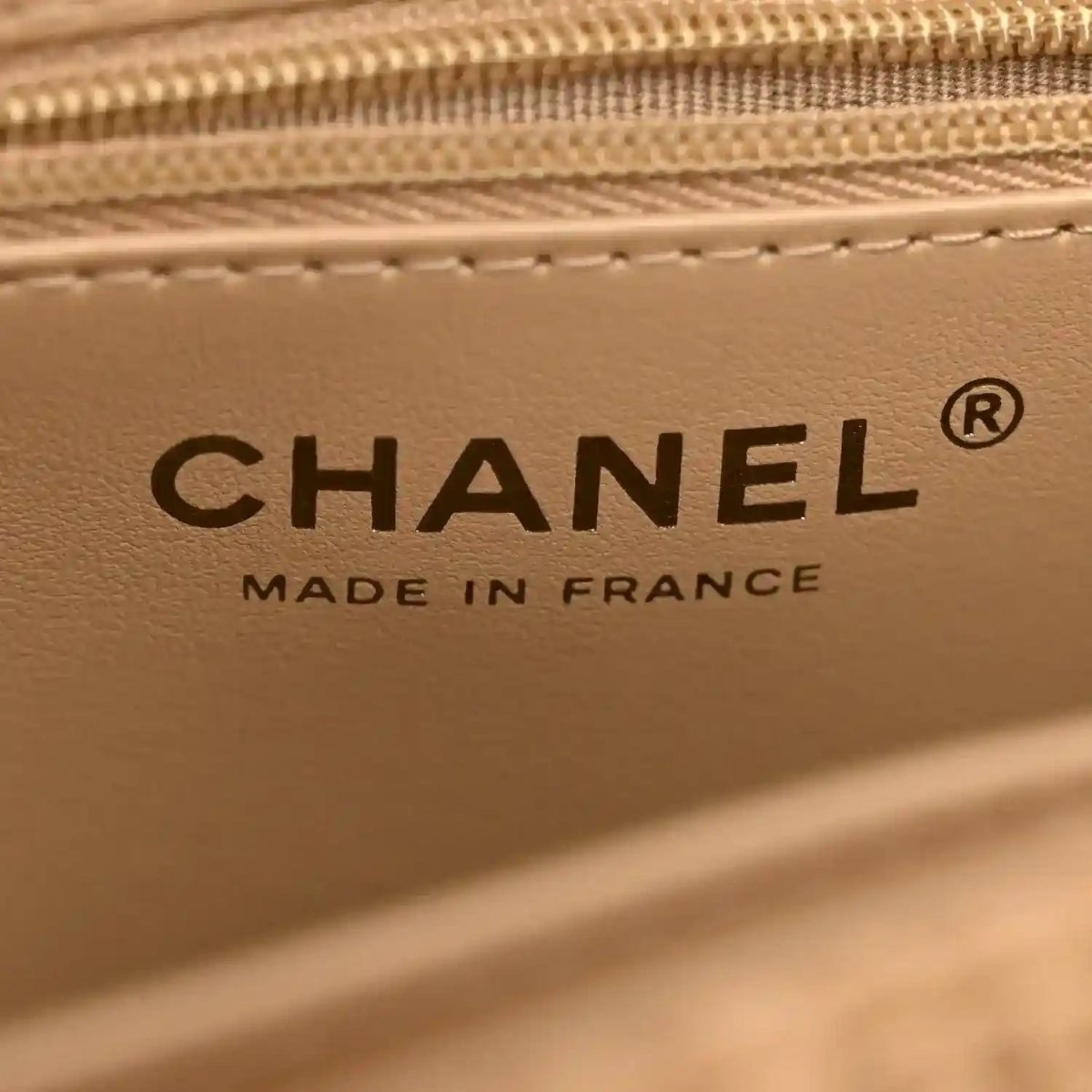 Beige leather interior panel with Chanel logo and Made in France text