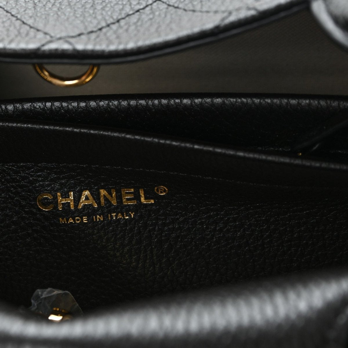 CHANEL black grained calfskin bag with gold logo and “Made in Italy” text