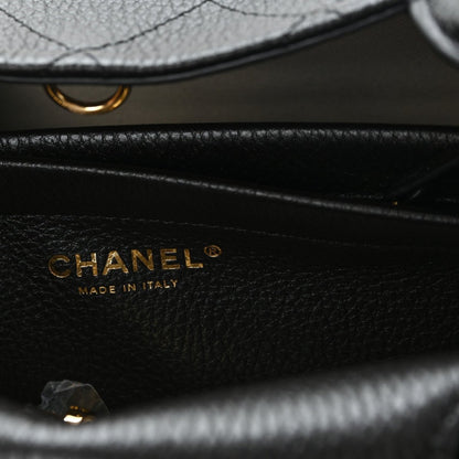 CHANEL black grained calfskin bag with gold logo and “Made in Italy” text