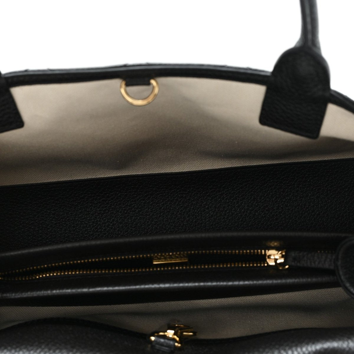 Black shopping bag interior with gold-tone zipper and stitched lining