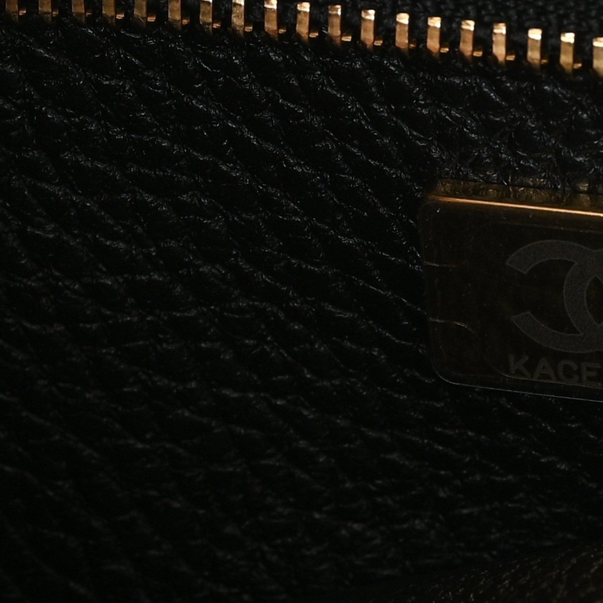 Black textured lining panel with zipper track and embossed detail