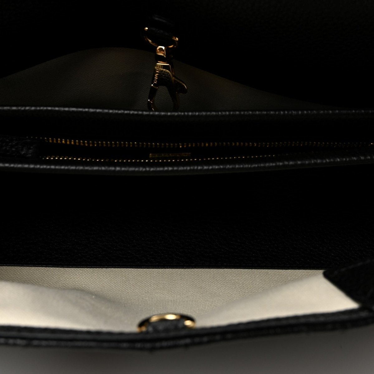 Black zipper close-up inside small shopping bag with metal pull tab