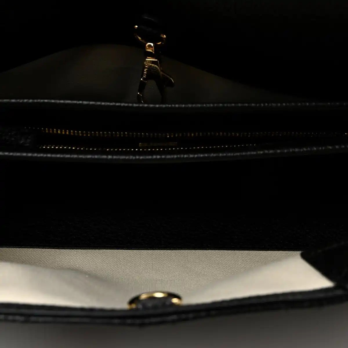 Black zipper close-up inside small shopping bag with metal pull tab