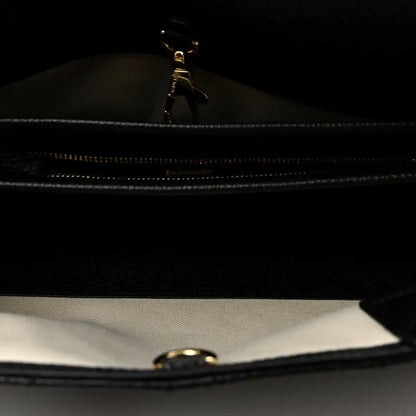 Black zipper close-up inside small shopping bag with metal pull tab