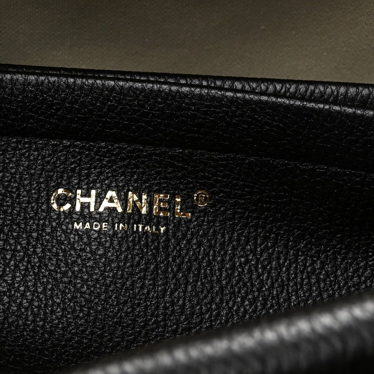 Black grained leather interior label reading CHANEL and MADE IN ITALY