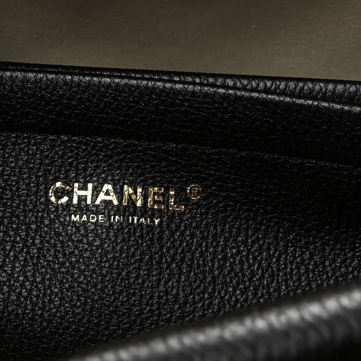 Black grained leather interior label reading CHANEL and MADE IN ITALY