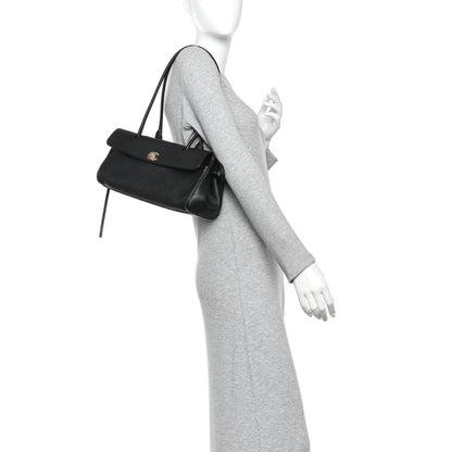 Black small shopping bag worn crossbody style, with top handle and front CC emblem