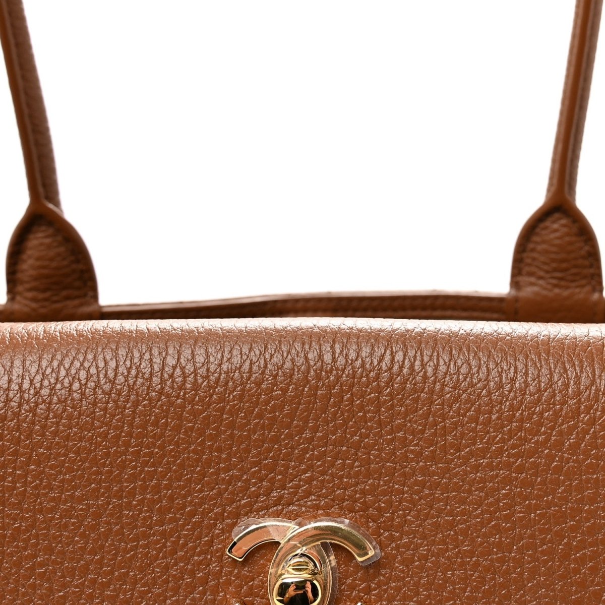 Camel brown grained leather front with metal CC logo detail centered on bag.