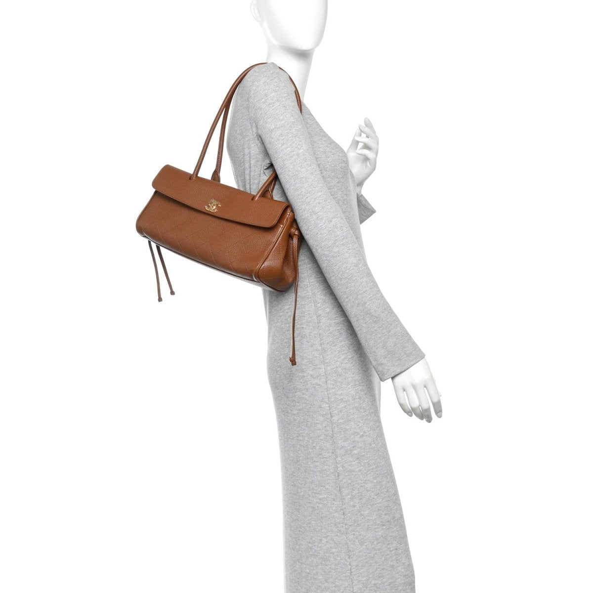 Camel brown small shopping bag worn with a thin shoulder strap and top handles.