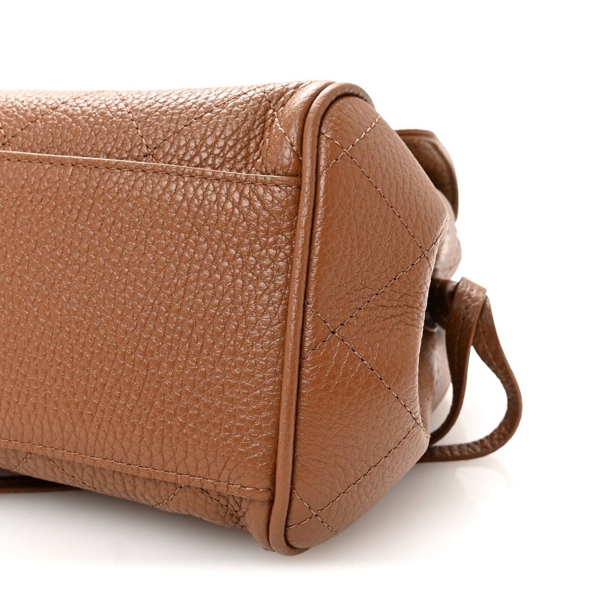 Camel brown small shopping bag side panel with corner seam and attached strap loop.