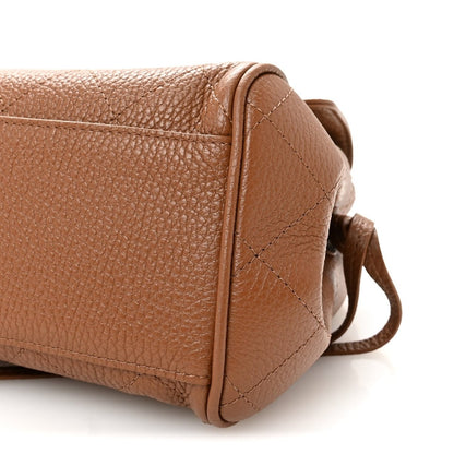 Camel brown small shopping bag side panel with corner seam and attached strap loop.