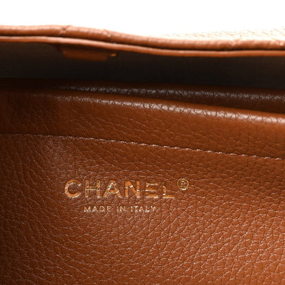 Chanel stamp on camel brown grained leather panel, with “Made in Italy” text.