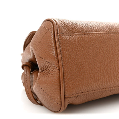Camel brown leather corner detail with top-stitching along the side seam.
