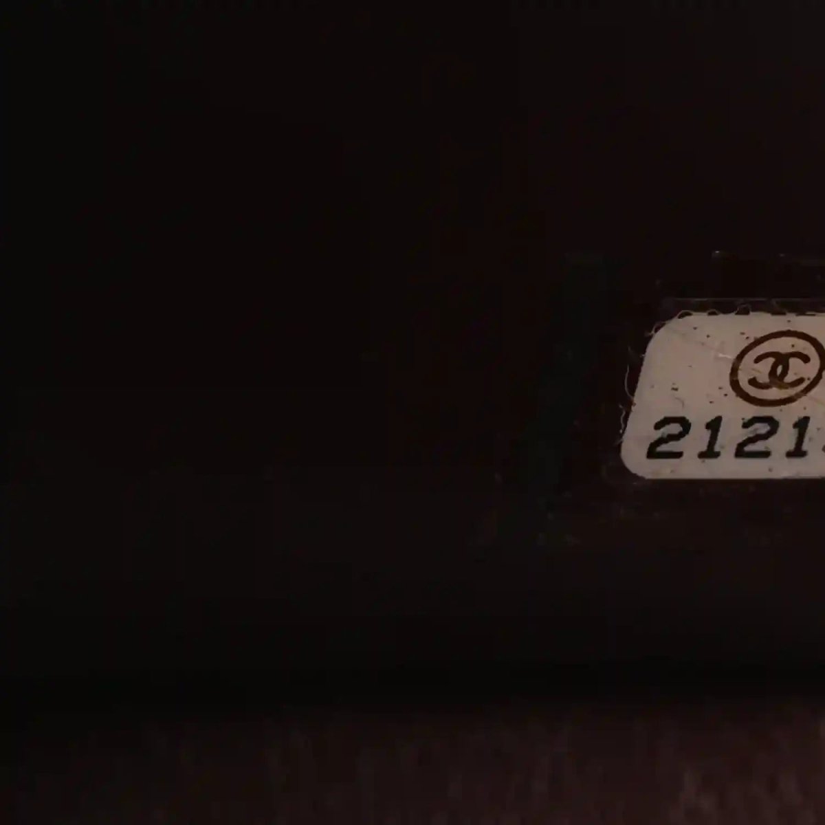 Chanel serial number tag with “CHANEL” logo on inside panel