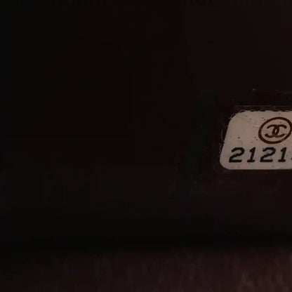 Chanel serial number tag with “CHANEL” logo on inside panel
