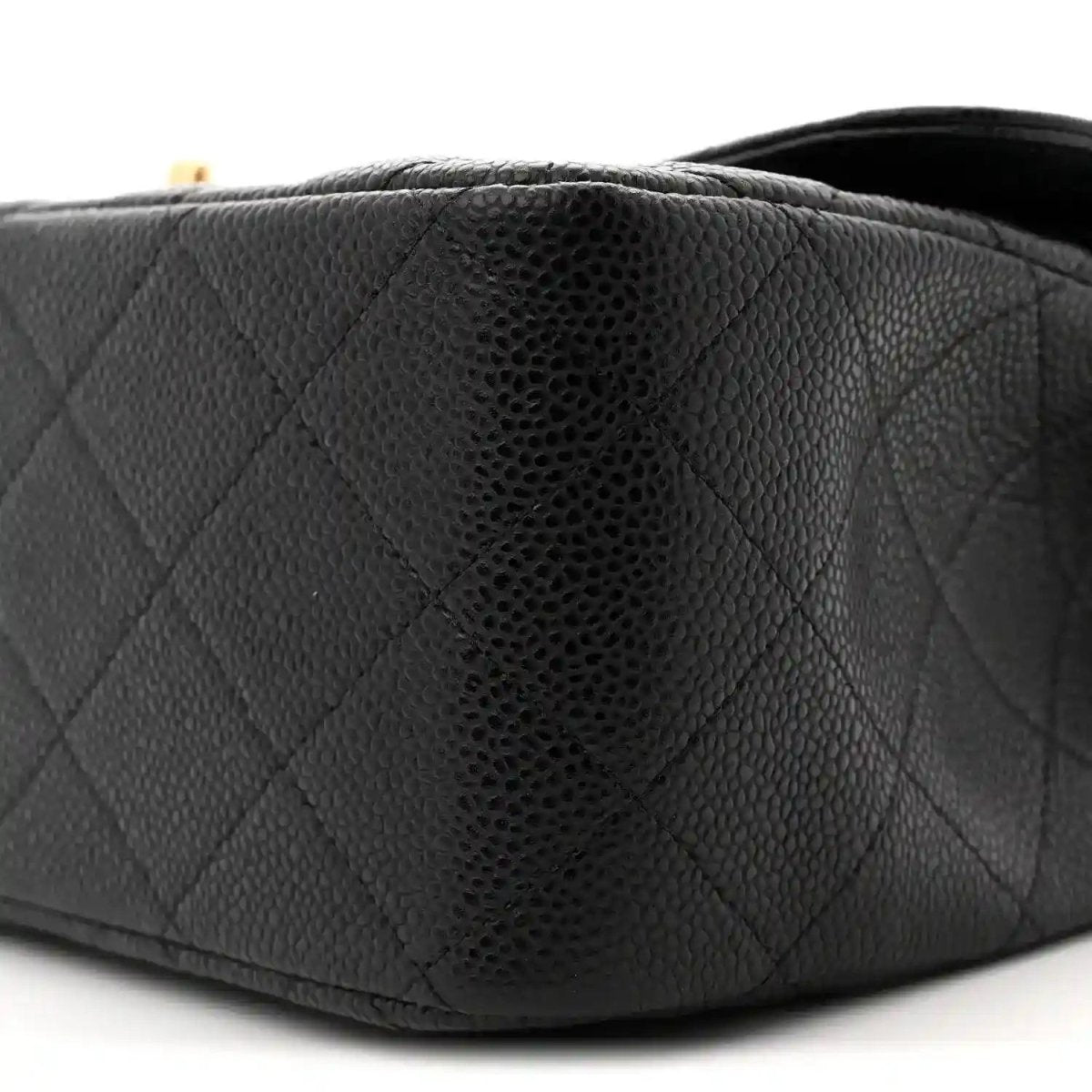 Chanel double flap bag corner close-up in black textured leather quilting