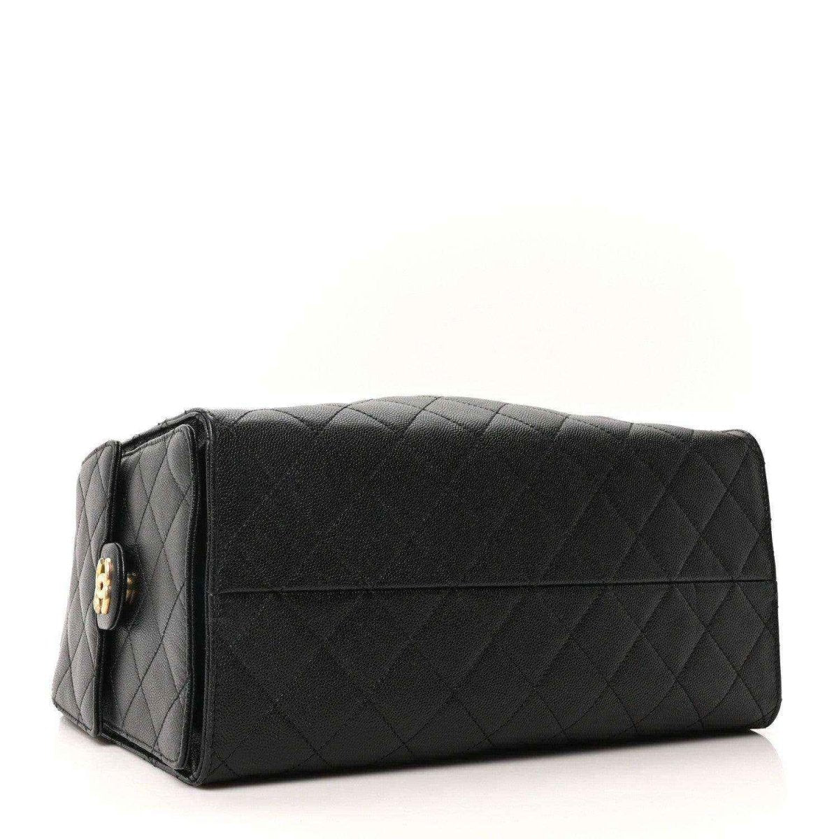 Black quilted leather handbag with top flap and gold turn-lock detail