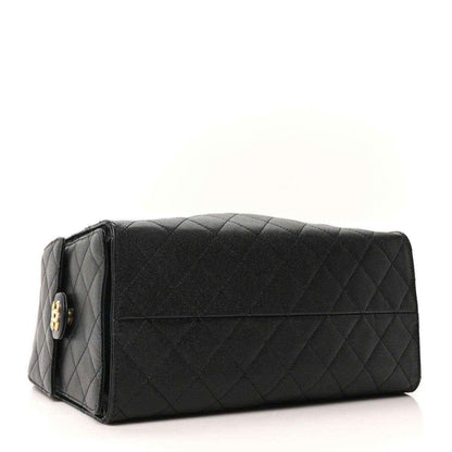 Black quilted leather handbag with top flap and gold turn-lock detail