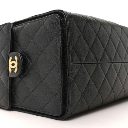 Black quilted leather handbag side panel with gold Chanel turn-lock detail