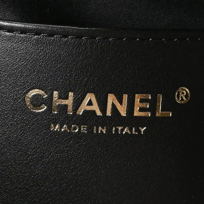 Chanel logo stamp on black leather handbag