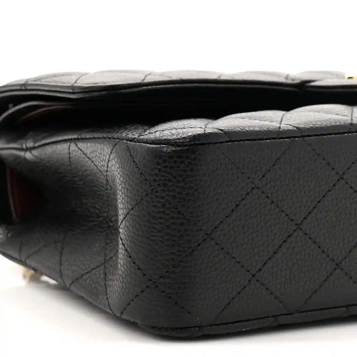 Black quilted caviar leather flap bag side profile with stitched panels