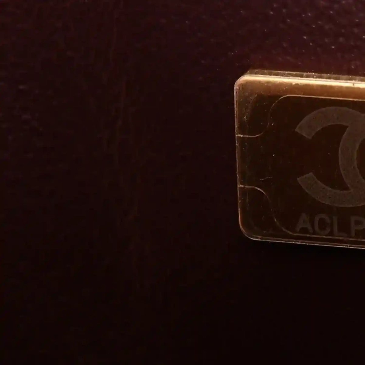 Gold-tone corner hardware with engraved pattern on flap bag